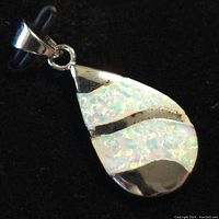 Close-up front view of the sterling silver pendant with iridescent opalite inlay showing the polished finish and teardrop shape.