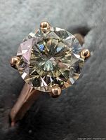 Front view of round brilliant lab-grown diamond and four-prong yellow gold setting