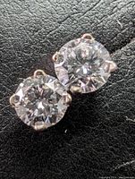 Close-up of both round brilliant diamonds in 4-prong white gold settings