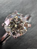 Close-up of round brilliant diamond and six-prong white gold setting