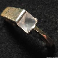 Close-up top angle view of the sterling silver ring showing the rose quartz gemstone and band surface.