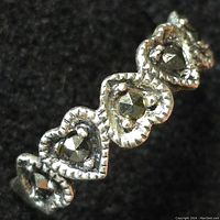 Close-up image of the sterling silver marcasite ring highlighting heart-shaped settings with marcasite stones on a textured silver band.