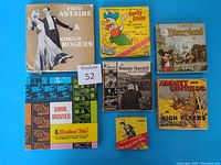 Overview showing all 7 film reels with original colorful boxes featuring vintage graphics and titles.