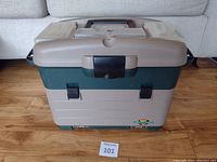 Closed view of Flambeau Kwikdraw tackle box showing front side with handle, two side locks, central latch, and top compartments.