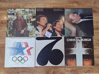 Top view of 6 LP albums laid out on wooden surface showing cover artwork and condition of sleeves.
