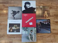 Overview photo showing all four LP album covers arranged on wood floor