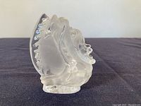 Side view of the carved rock crystal dragon figurine showing detailed wing and head features.
