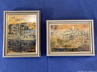 Two framed copper engravings lying flat showing detailed scenes of boats and an estate.