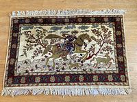 Full view of hand knotted wool pictorial rug with rider on horse design and floral border, showing overall condition and design details.