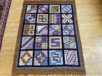 Full view of the hand woven wool rug laid on wood floor.