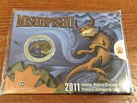 2011 Canadian Mythical Creatures series packaging with Mishepishu coin mounted, showing artistic design and title.