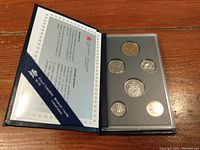Opened folder containing six uncirculated Canadian coins from 1992 in protective display.