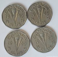 Four 1945 Canadian Victory nickels showing reverse side with torch and V design, year 1945, and maple leaves.