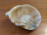 Top-down view of the carved onyx bowl displaying smooth polished surface and natural marble veining patterns in white, brown, and grey shades