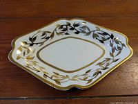 Top view of the vintage hand-painted serving dish showing gold leaf decoration and unique geometric shape.