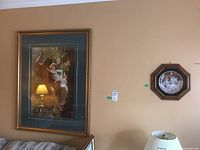 The lot includes a large decorative print in a gold-toned wood frame and a smaller decorative plate in an octagonal wood frame, both hanging on a wall.