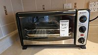 Front view of Bravetti TO283B toaster oven with label and control knobs visible