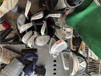 Photo shows multiple golf irons and woods inside a golf bag with visible club numbers 5, 6, 8, 9, 10 and various branded club heads such as Tour Edge and Tour 360.