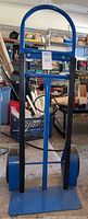 Front view of the blue hand truck showing handle and frame structure.