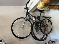 Side view of the full Kent Shockwave bicycle to show frame, tires, and extra wheels hung on the frame.