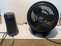 Photo of the Vornado fan and black home heater showing size and condition. Both items are dusty but appear intact.