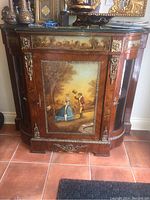 Full front view of cabinet showing painted panel, marble top and side cupboards