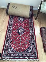 Partially unrolled runner on hardwood floor showing overall length and design