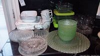 Overview of Correlle dishes, glass bowls, and baking dishes stacked on counter
