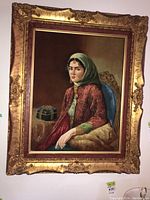 Front view of velvet portrait painting and full ornate gilt frame
