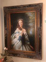 Full view of the framed oil painting depicting the young woman in landscape