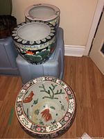 Overall view of two planters on plastic bin and one koi fish planter on floor