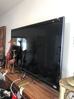 Front view of the Sony 52 inch television showing full screen and bezel with reflective surface.