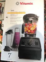 Front of Vitamix E320 Explorian Series Super Pack box showing blender and containers