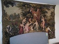 Full view of tapestry hung on wall with headboard in foreground