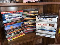 Two stacks of DVDs with various movies and series titles visible