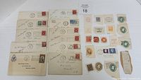 Over 30 Canadian postage stamps on loose pieces of paper and envelopes, various colors and denominations visible.