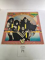 Front view of Hotter Than Hell album cover with band image and title visible.
