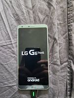LG G6 ThinQ smartphone powered on showing the boot logo screen