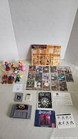 Photo of Nintendo character toys, trading cards, game cartridges, and manuals