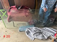 Large beveled glass panel resting vertically against furniture, showing clarity and edge beveling.