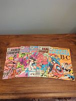 Five Marvel Universe comics issues 2 through 6 arranged on a wooden surface showing cover art and general condition.