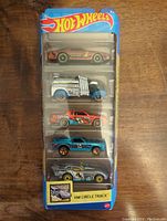 Front view of sealed Hot Wheels five-pack showing five different muscle car models in packaging