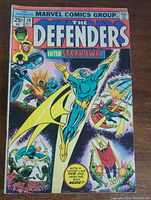 Front cover of The Defenders issue #28 comic book showing Starhawk and other characters in action with price 25 cents and published by Marvel Comics Group in 1975.