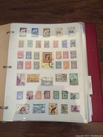 Photo of a page of assorted stamps featuring various denominations and designs from Australia and India among others.