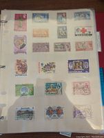 Page featuring stamps from Bermuda including flora, historical events, and portraits in various colors and denominations