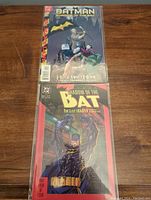 Front view of two Batman comics, Shadow of the Bat #4 and #86, bagged, showing detailed front covers with Batman featured.