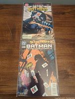 Photo showing two Batman Detective Comics in protective bags, issue #701 on top.