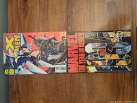 Two Marvel comic books side by side showing the full front covers with titles The Uncanny X-Men 319 and Marvel The Year in Review