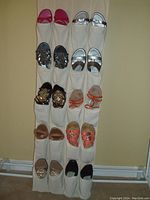Photo of 10 pairs of assorted ladies sandals and casual shoes organized in a hanging shoe holder, showing various colors including pink, silver, brown, orange and beige.