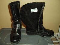 Black leather women's boots with fleece lining, side zipper open to show interior tag and lining